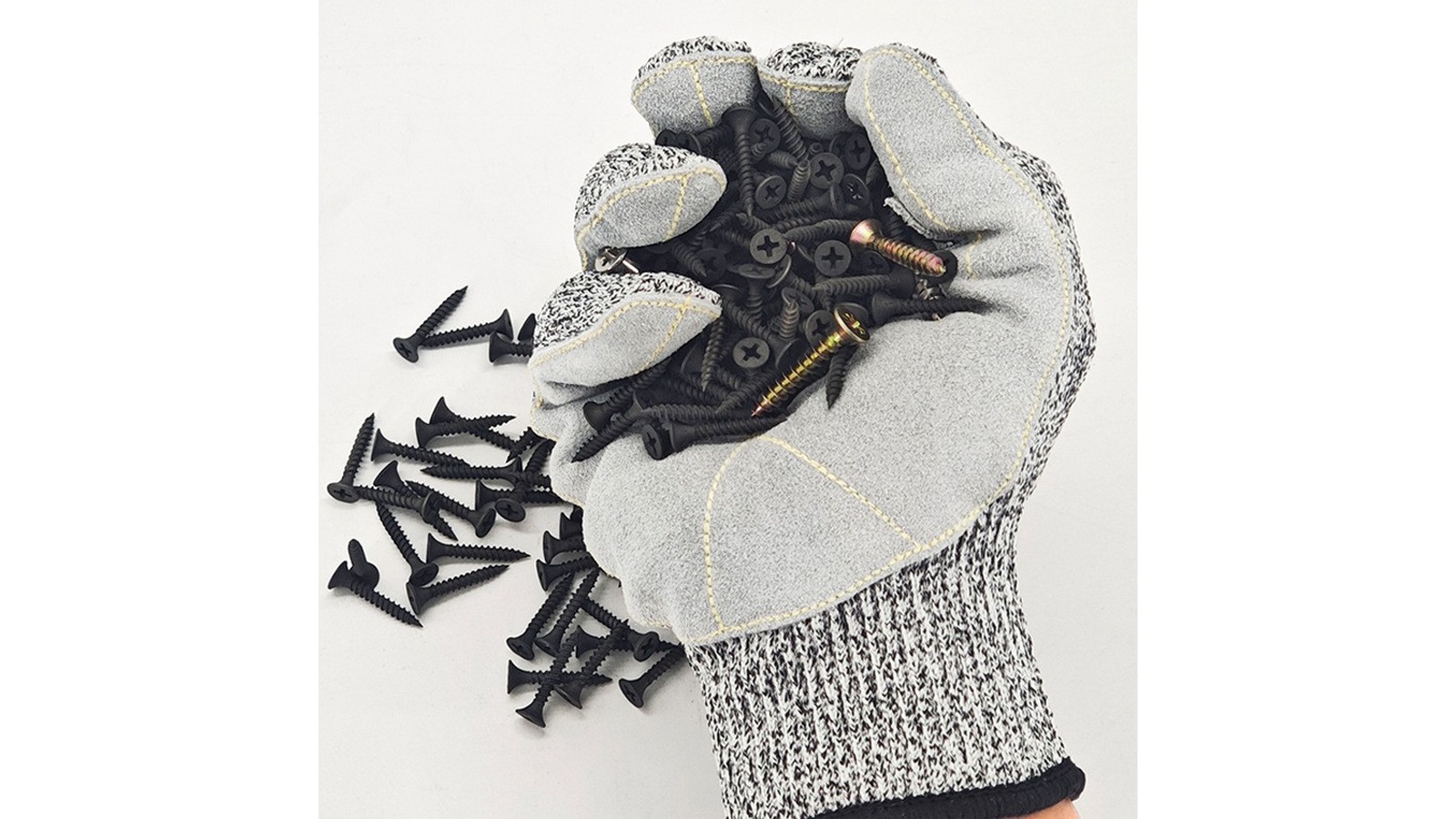 Grey leather-patched HPPE glove gripping a handful of black screws