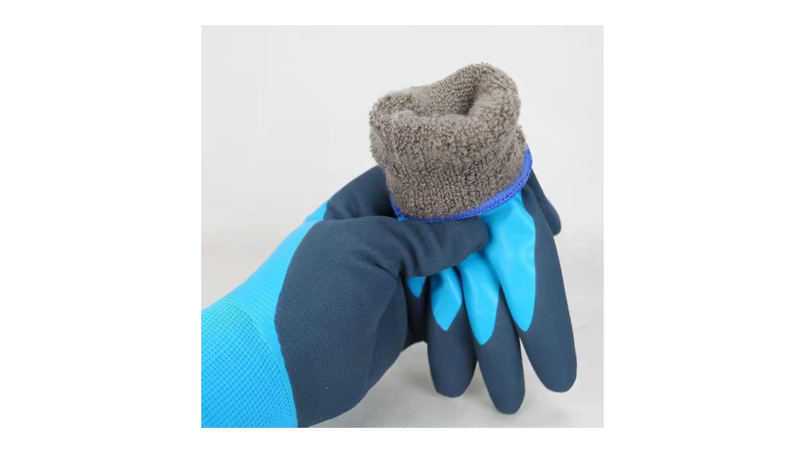Navy winter work glove with bright blue latex palm and grey fleece lining folded over the cuff